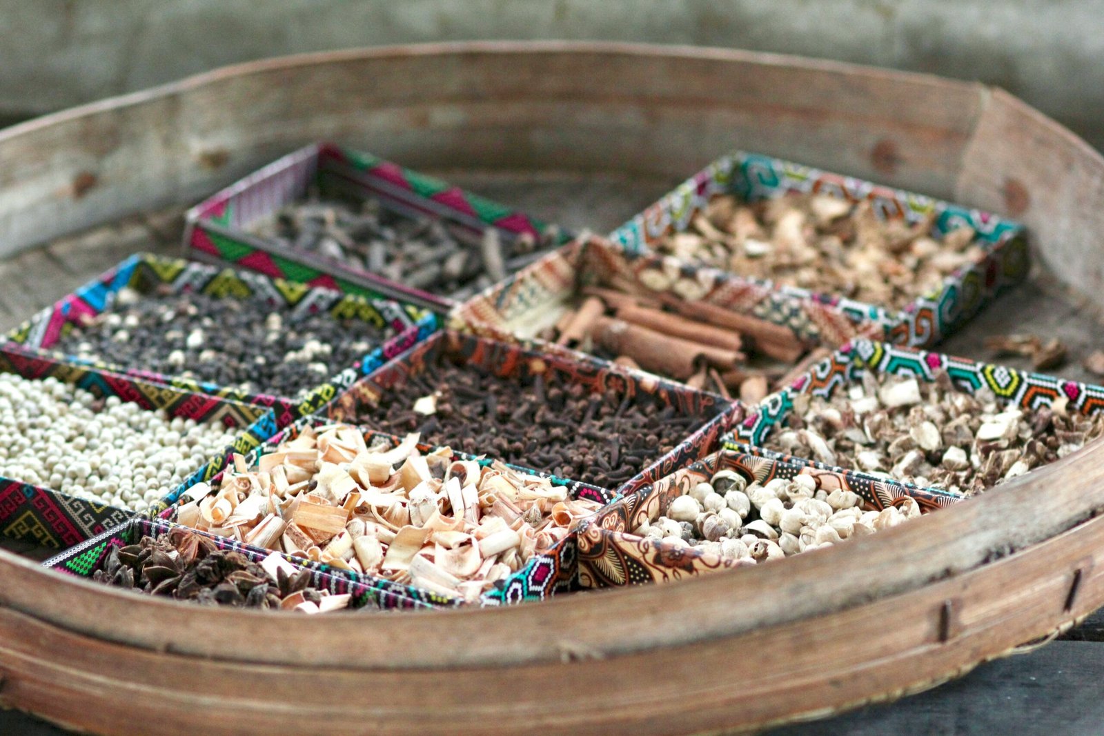 Assorted spices used in traditional desert meals displayed on a rustic table.