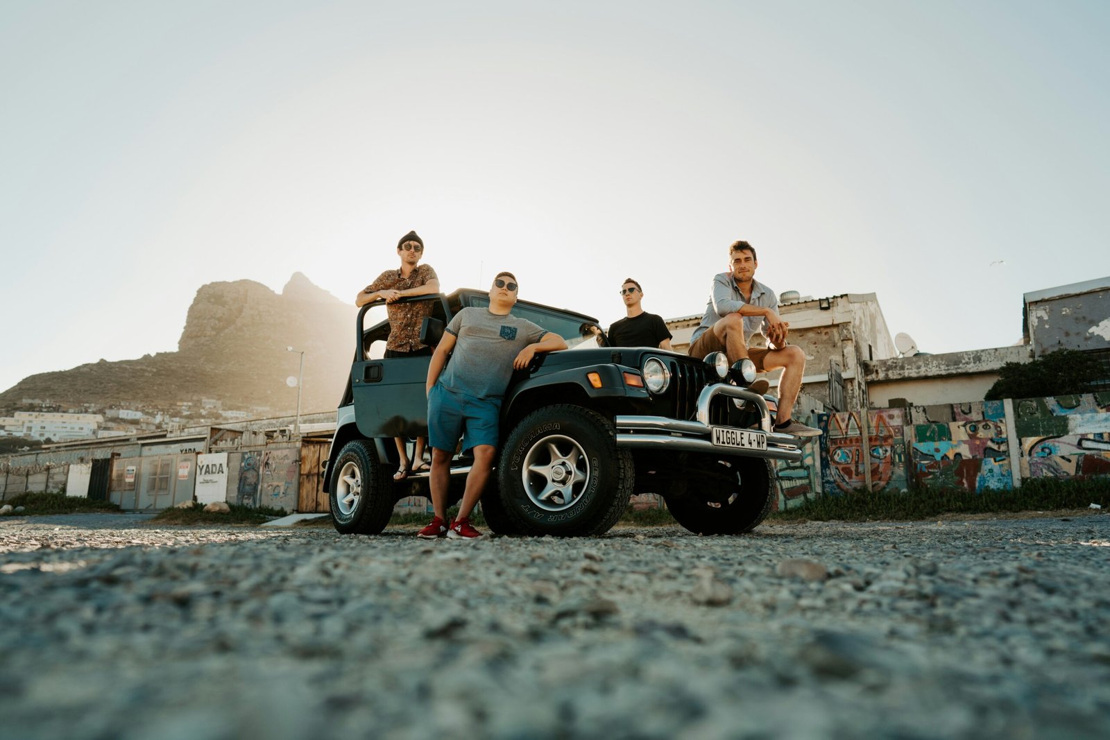 Group of tourists posing near quad bikes after a desert safari ride.