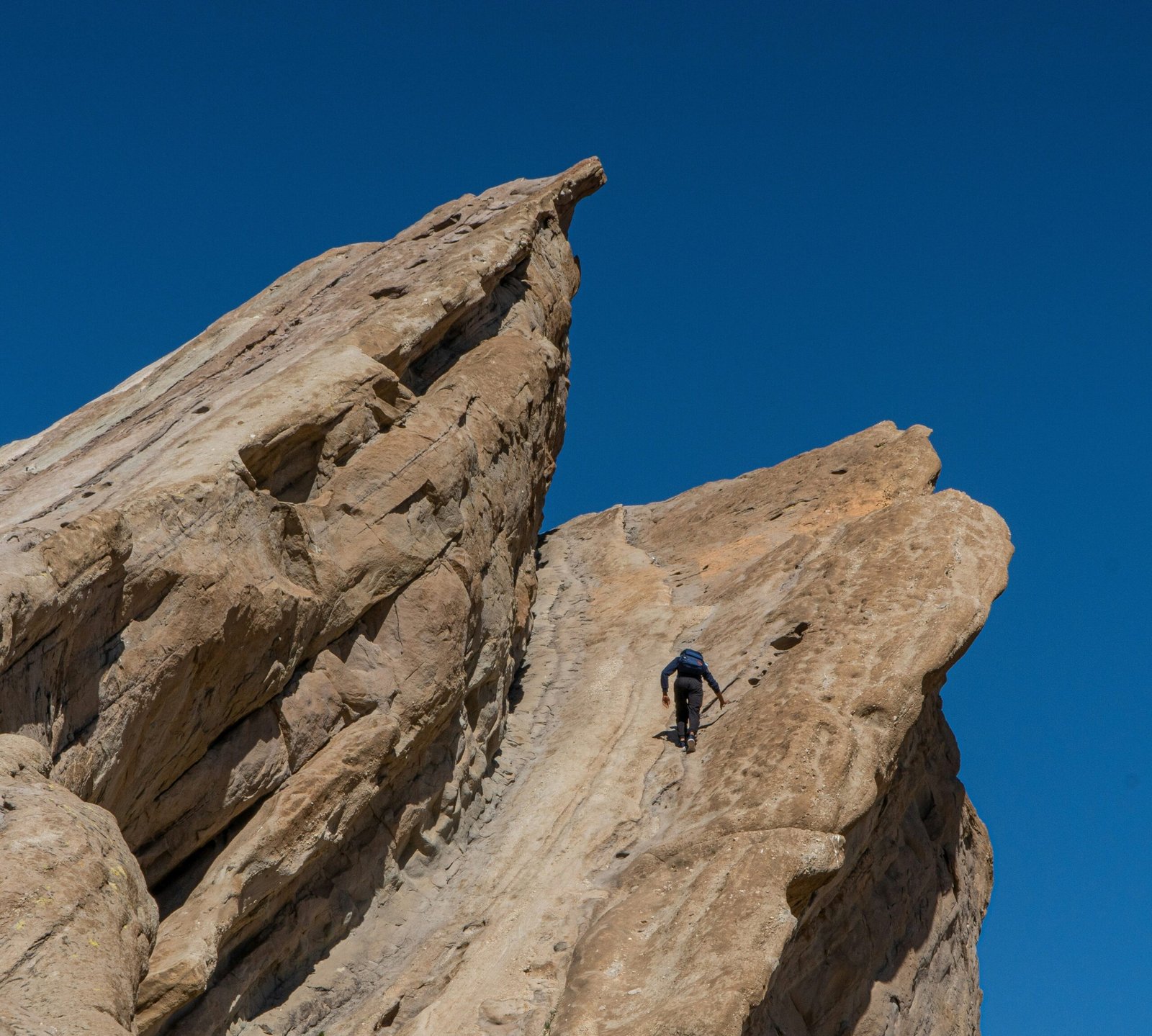 Illustration showing two climbers taking different routes: one using a zigzag method and another attempting a direct ascent.