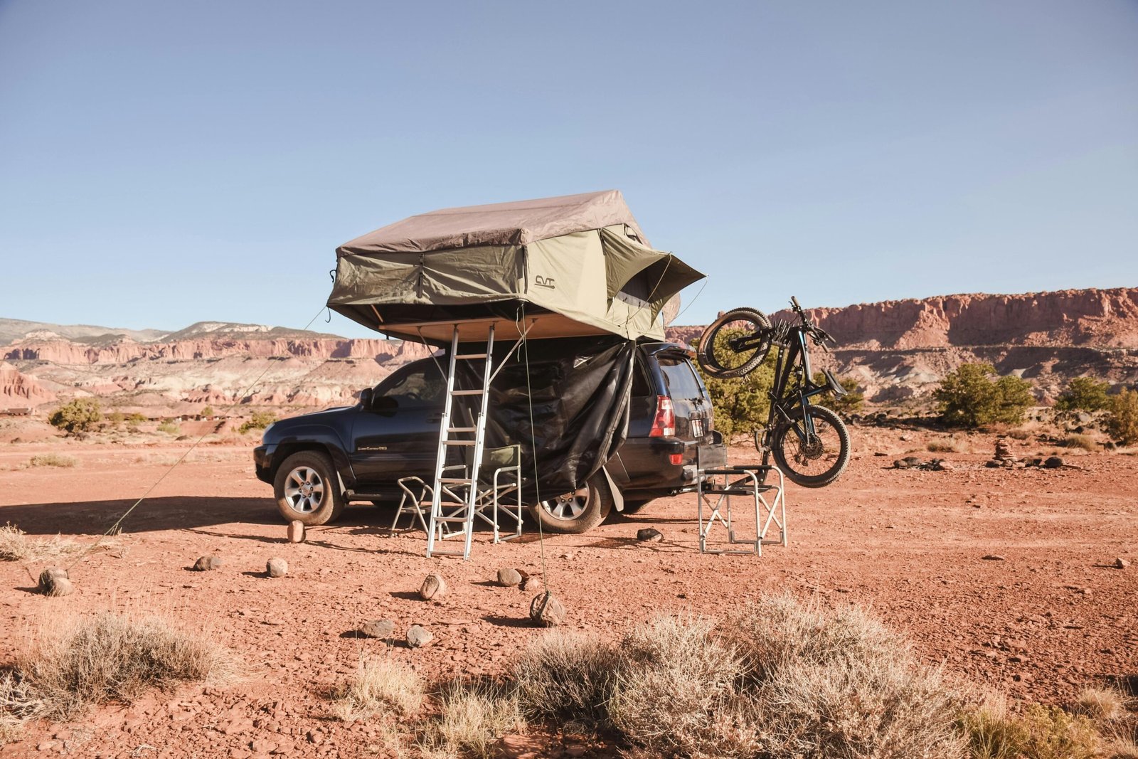 Perfectly set up desert camping scene with tent, chairs, and supplies