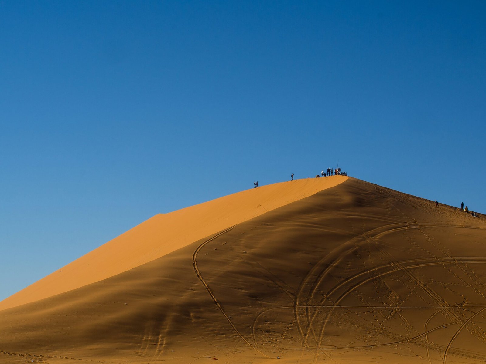 A stunning desert sunset over golden sand dunes