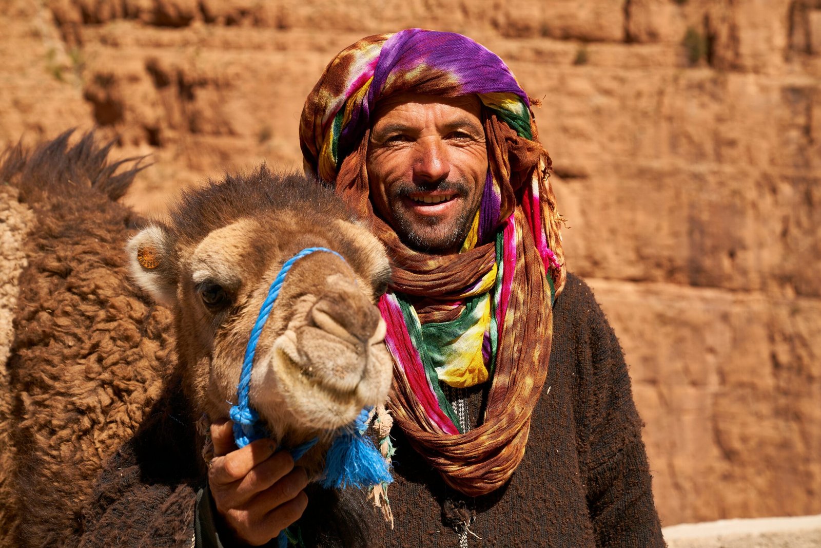 Berber musicians playing drums by firelight surrounded by seated travelers