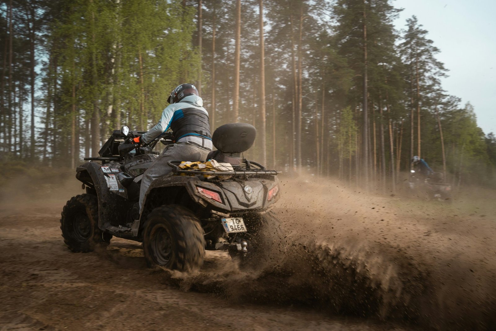 Close-up shot of a rider’s hands gripping handlebars tightly on an ATV