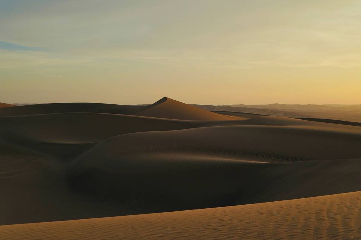 Quad bike silhouetted against vibrant sunset colors
