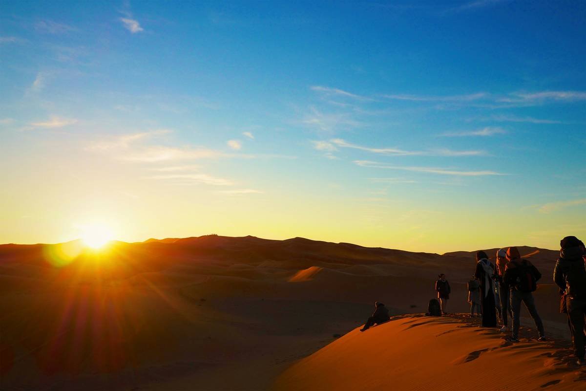Tourists participating in a sand art workshop led by a local artist.