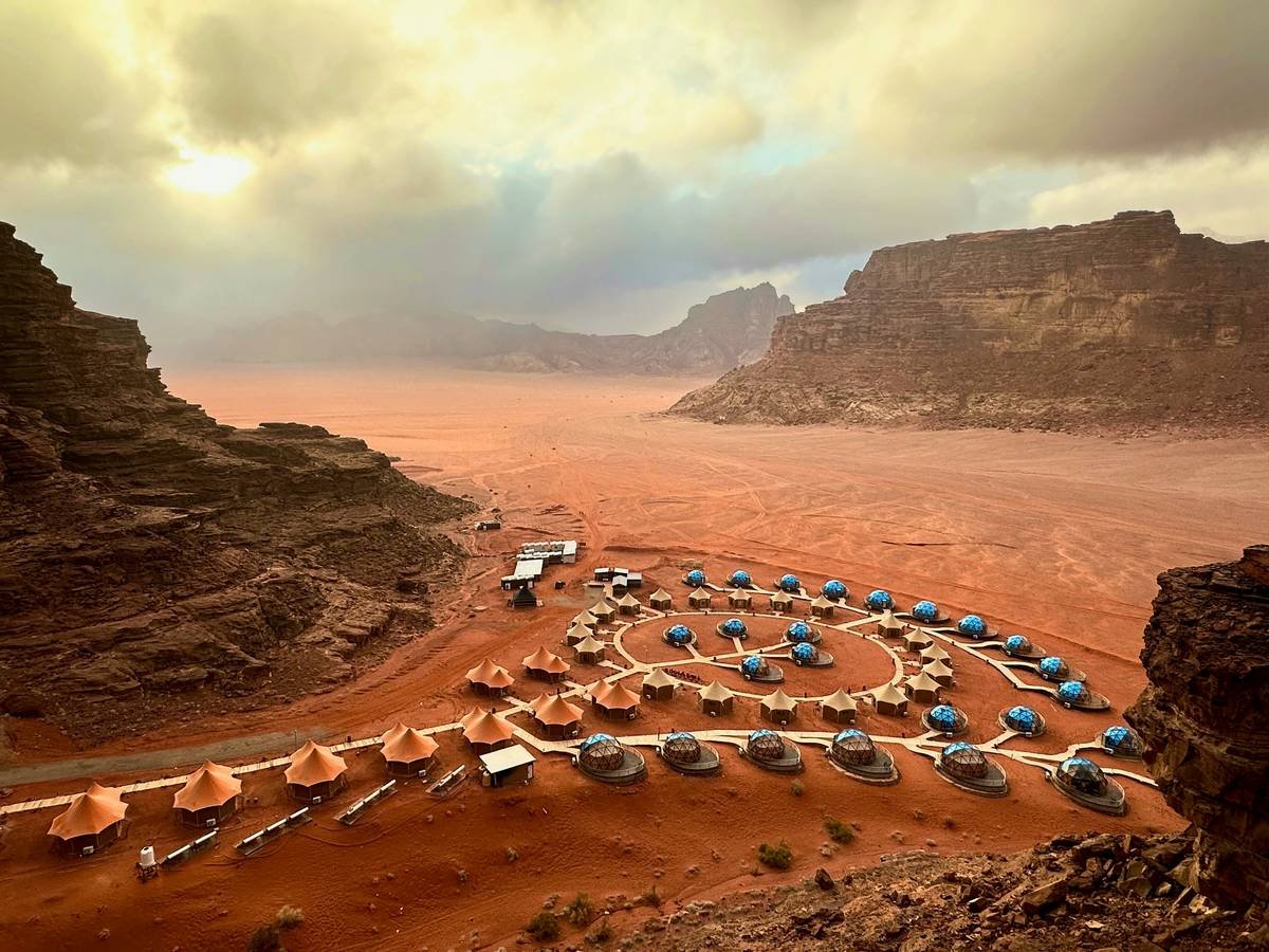 Tourists riding camels across sandy dunes during a morocco desert safari
