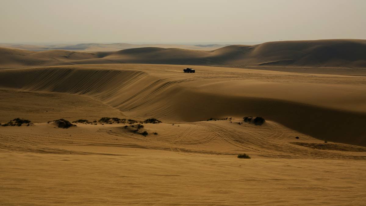 A beautiful sunset over rolling sand dunes in the desert