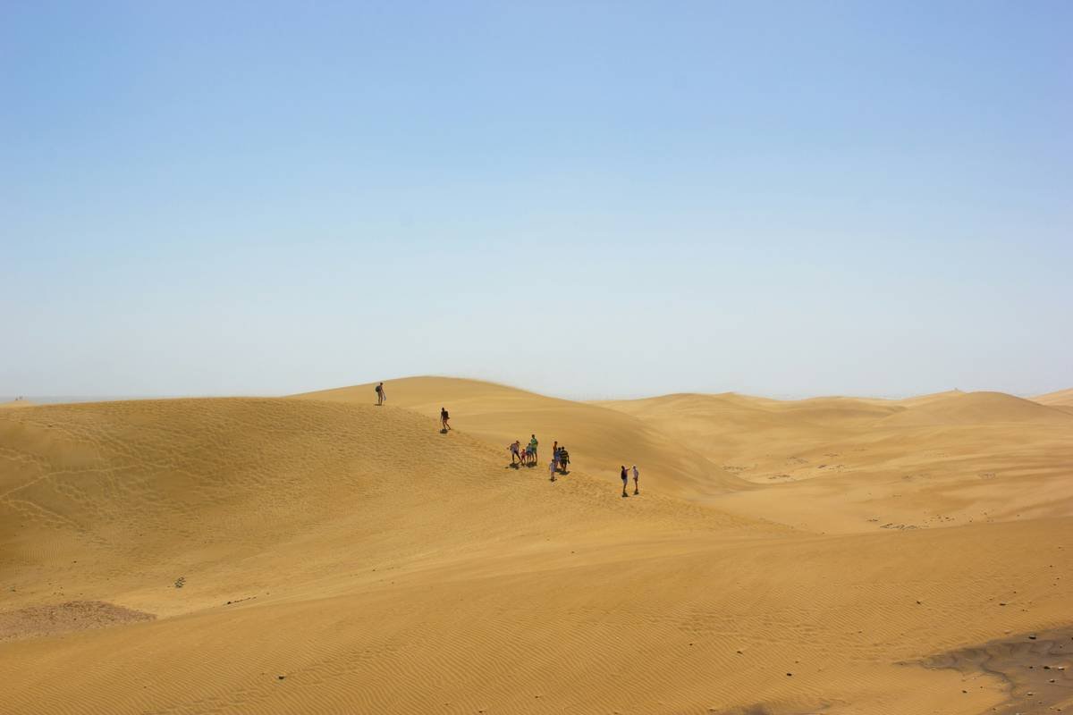 A stunning desert sunset with golden sand dunes during a guided tour.