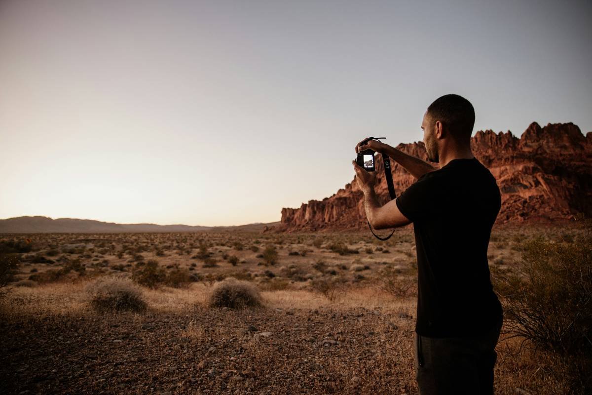 Golden hour shot of rolling sand dunes with sunlight casting long shadows