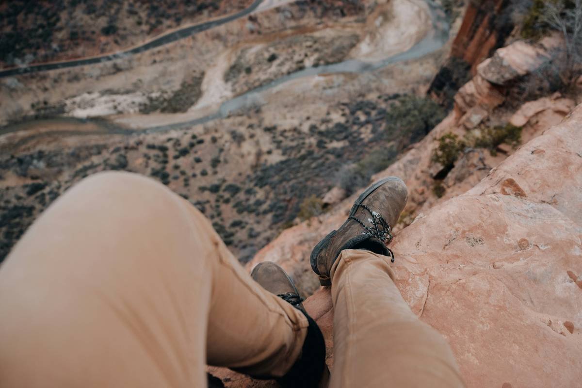 Side-by-side comparison of cotton jeans vs. technical desert hiking pants showing moisture-wicking, UPF rating, and abrasion resistance