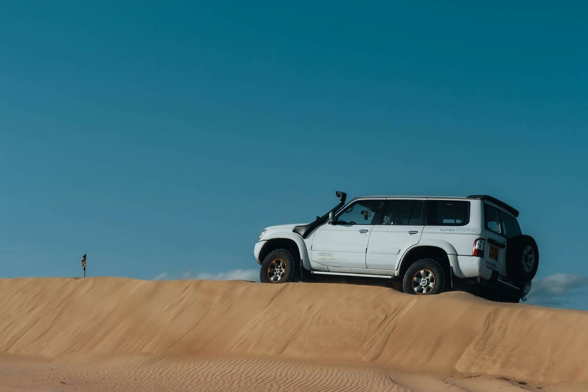 Close-up of expert driver during intense dune adventure desert safari booking bashing session in UAE desert