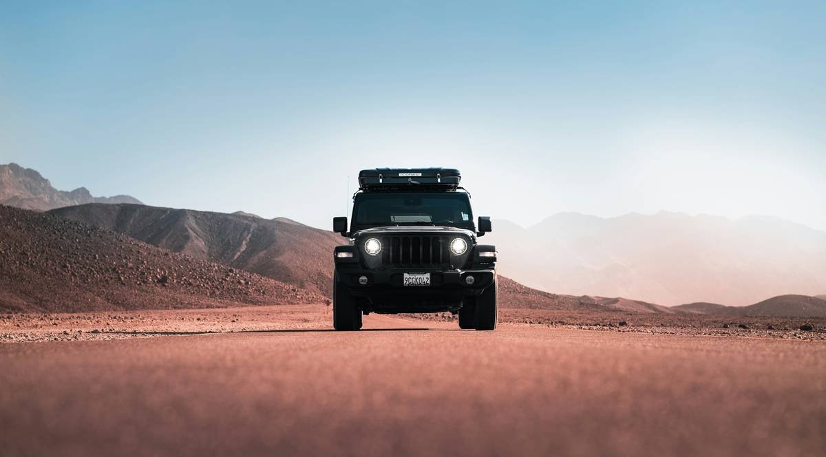 dune adventure desert safari bashing out showing tire tracks vanishing into golden desert expanse