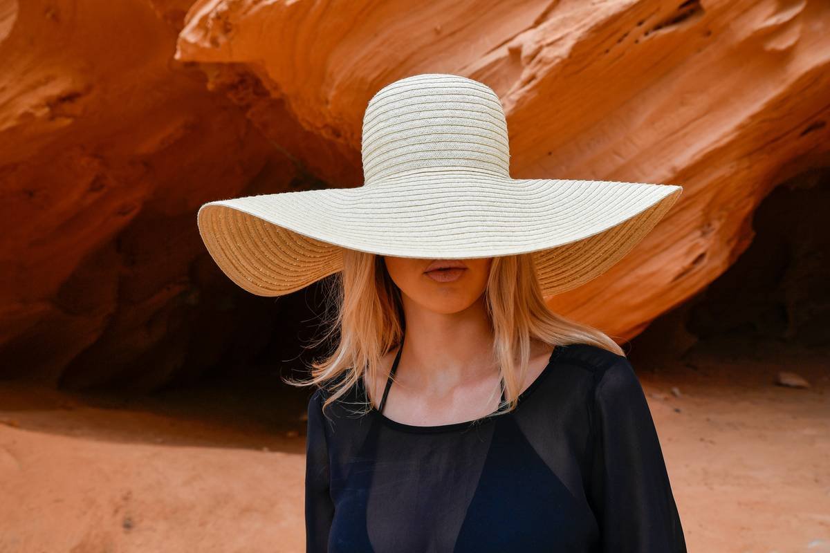 Essential desert hiking attire checklist including hat, loose linen shirt, gaiters, and trail runners